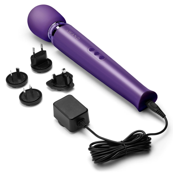 Purple rechargeable wand massager with charging accessories.