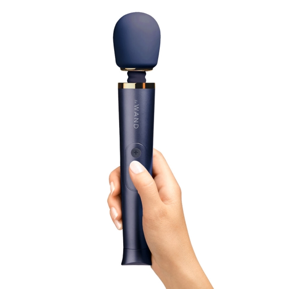 Navy silicone rechargeable wand vibrator held by a hand.