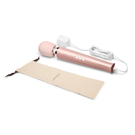 Rose gold plug-in wand massager with charging cord and storage bag.