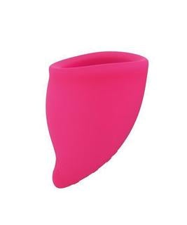 A bright pink reusable silicone menstrual cup.