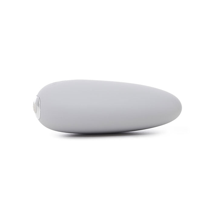 A light gray, pebble-shaped clitoral vibrator with a clear tip.