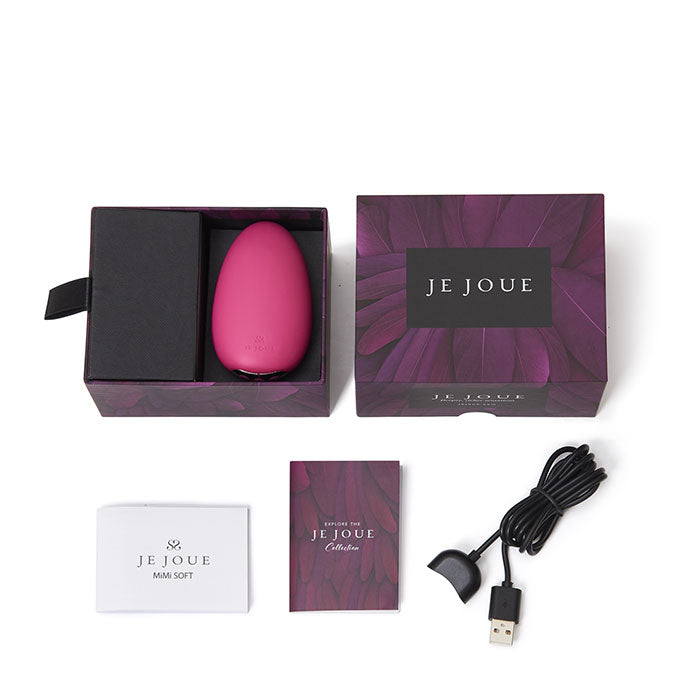 A pink Je Joue Mimi Soft vibrator in its box with accessories.
