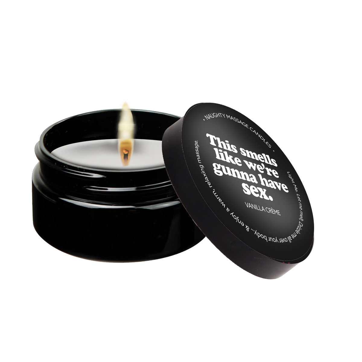 A black massage candle with a lit wick and text on the lid.