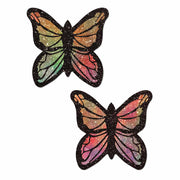 Two rainbow glitter butterfly pasties with black outlines.