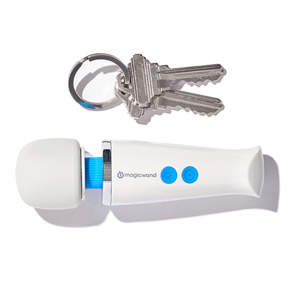 A white Magic Wand massager with blue buttons and a set of keys.
