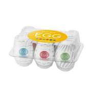 A six-pack of Tenga Egg disposable masturbators in a clear plastic case.