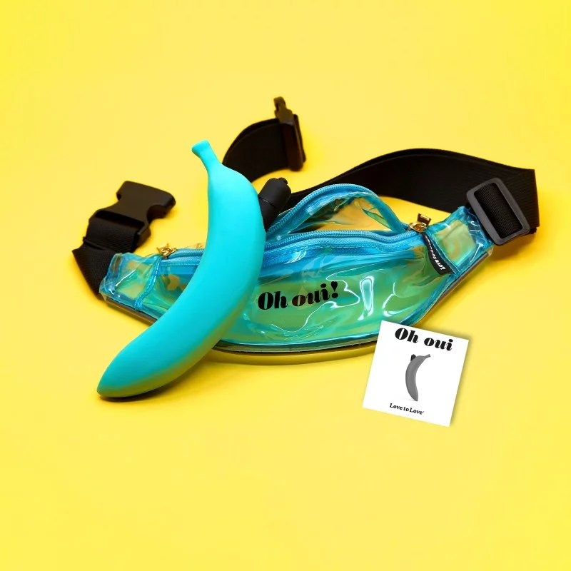 Blue silicone banana vibrator with "Oh oui" text on a clear fanny pack.