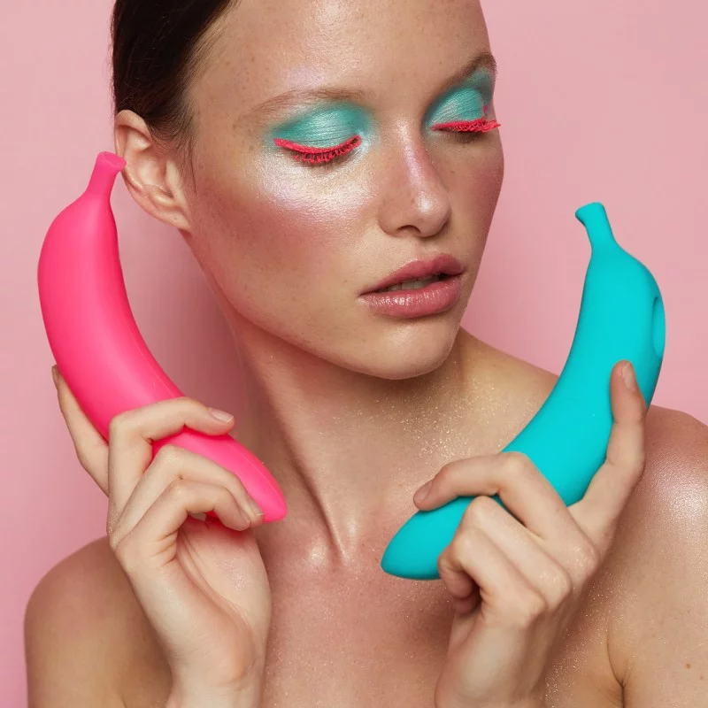 Pink banana-shaped silicone vibrator with 7 modes.