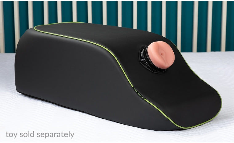 Black faux leather positioning pillow with a green trim and a flesh-toned opening.