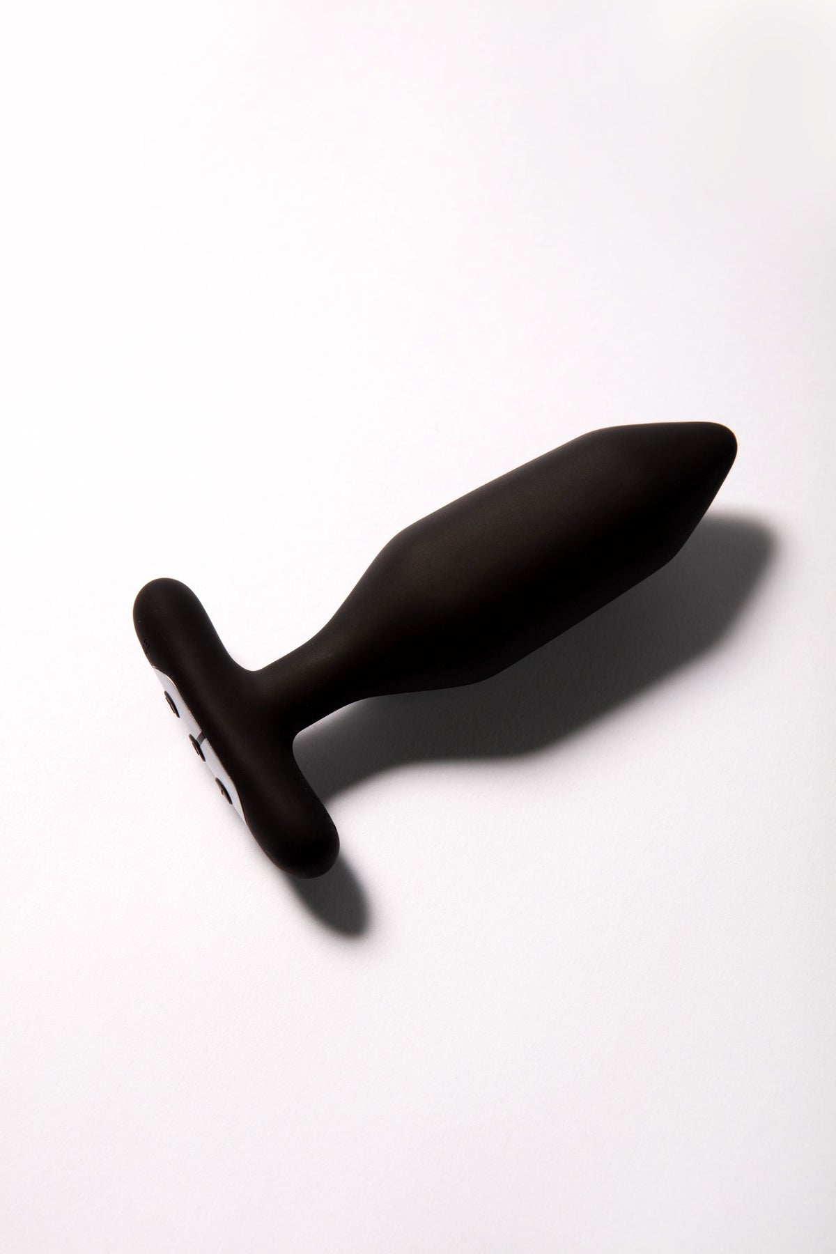 Black vibrating anal plug with a T-shaped handle and remote control.