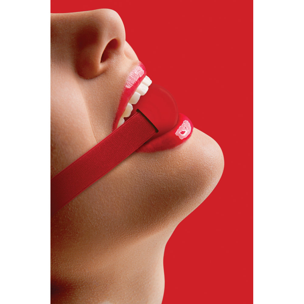 Red elastic strap ball gag with fabric comfort.
