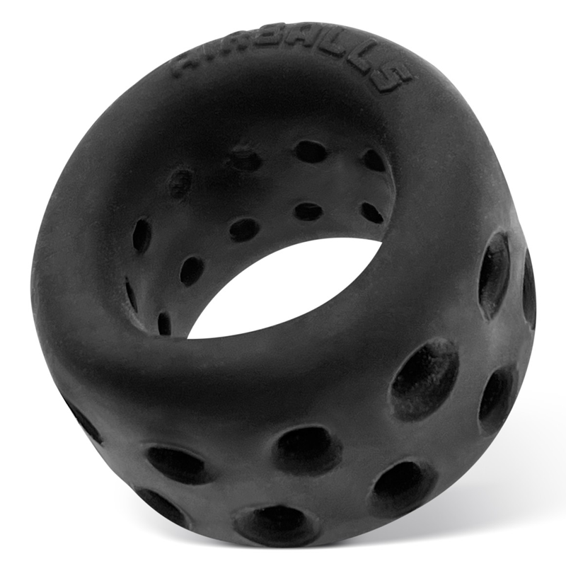 Black silicone ball stretcher with ventilation holes and embossed text.