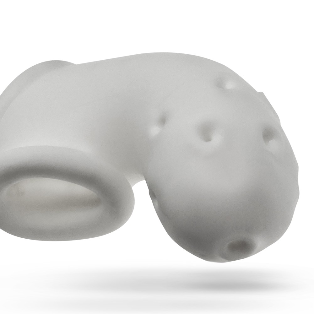 A white silicone chastity cage with ventilation holes.