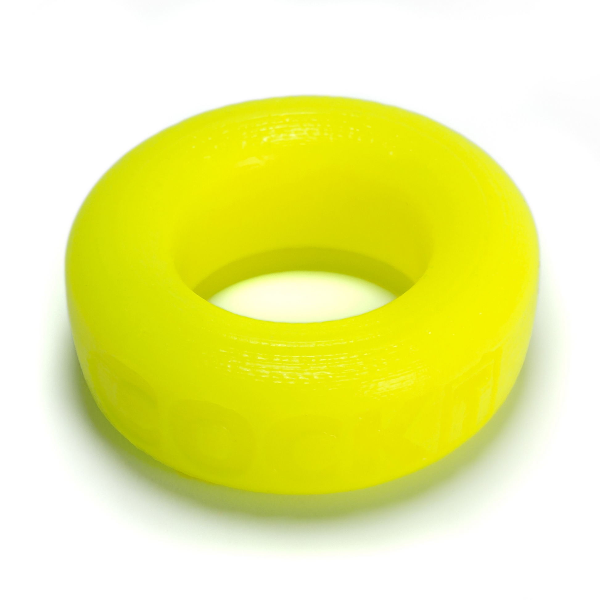 A bright yellow, soft silicone cock ring with visible texture.