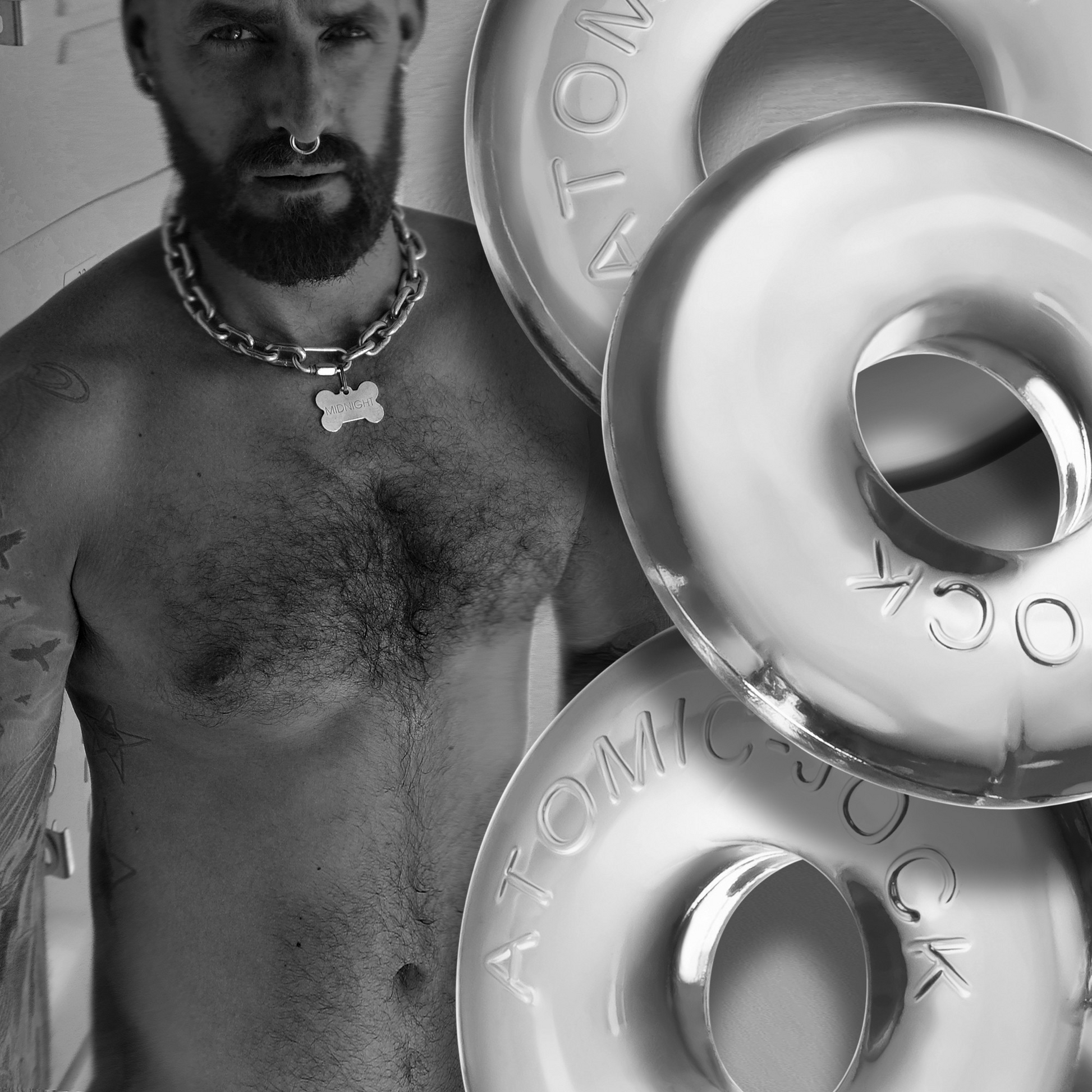 A man wears a chain collar with a bone tag, next to clear cock rings.