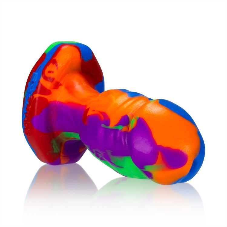 A small, rainbow-colored silicone anal plug with textured details.