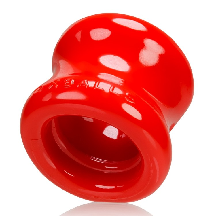 Red FLEXtpr ball stretcher with white polka dots and embossed text.