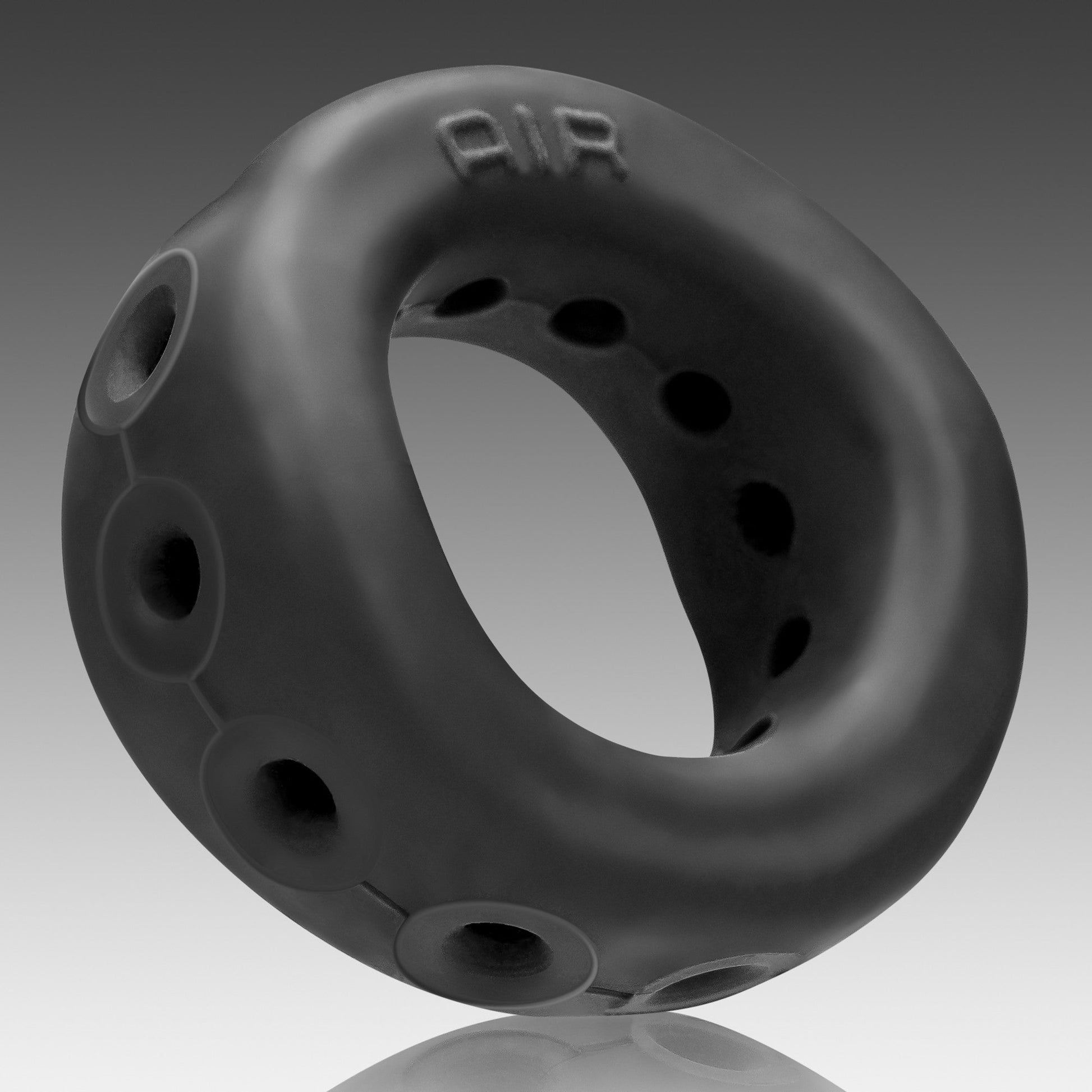 Black silicone airflow cock ring with multiple ventilation holes.