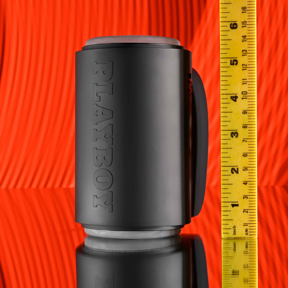 Black Playboy travel stroker with a ruler showing its height.
