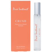Pure Instinct Crush Pheromone Infused Perfume in a clear spray bottle next to its orange box.