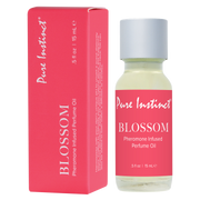 Pure Instinct Blossom Pheromone Infused Perfume Oil in a glass bottle with a pink label.