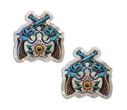 Two glittering nipple pasties shaped like crossed revolvers and a flower.