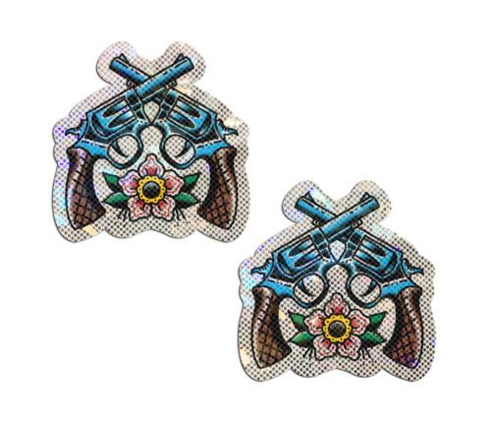 Two glittering nipple pasties shaped like crossed revolvers and a flower.