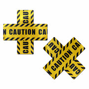 Yellow caution tape nipple pasties in a cross and X shape.