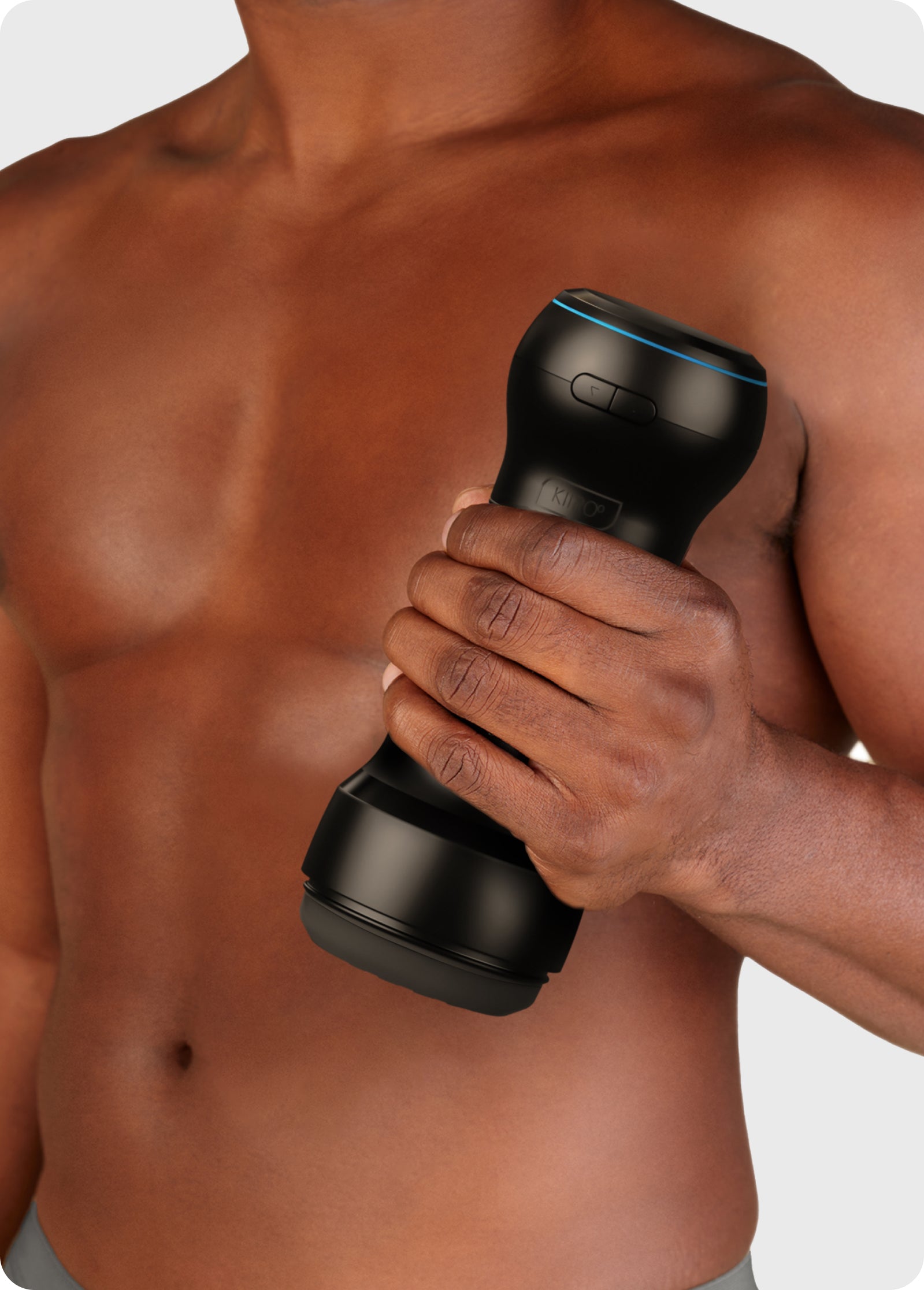 Man holding a black app-controlled stroker and suction device.