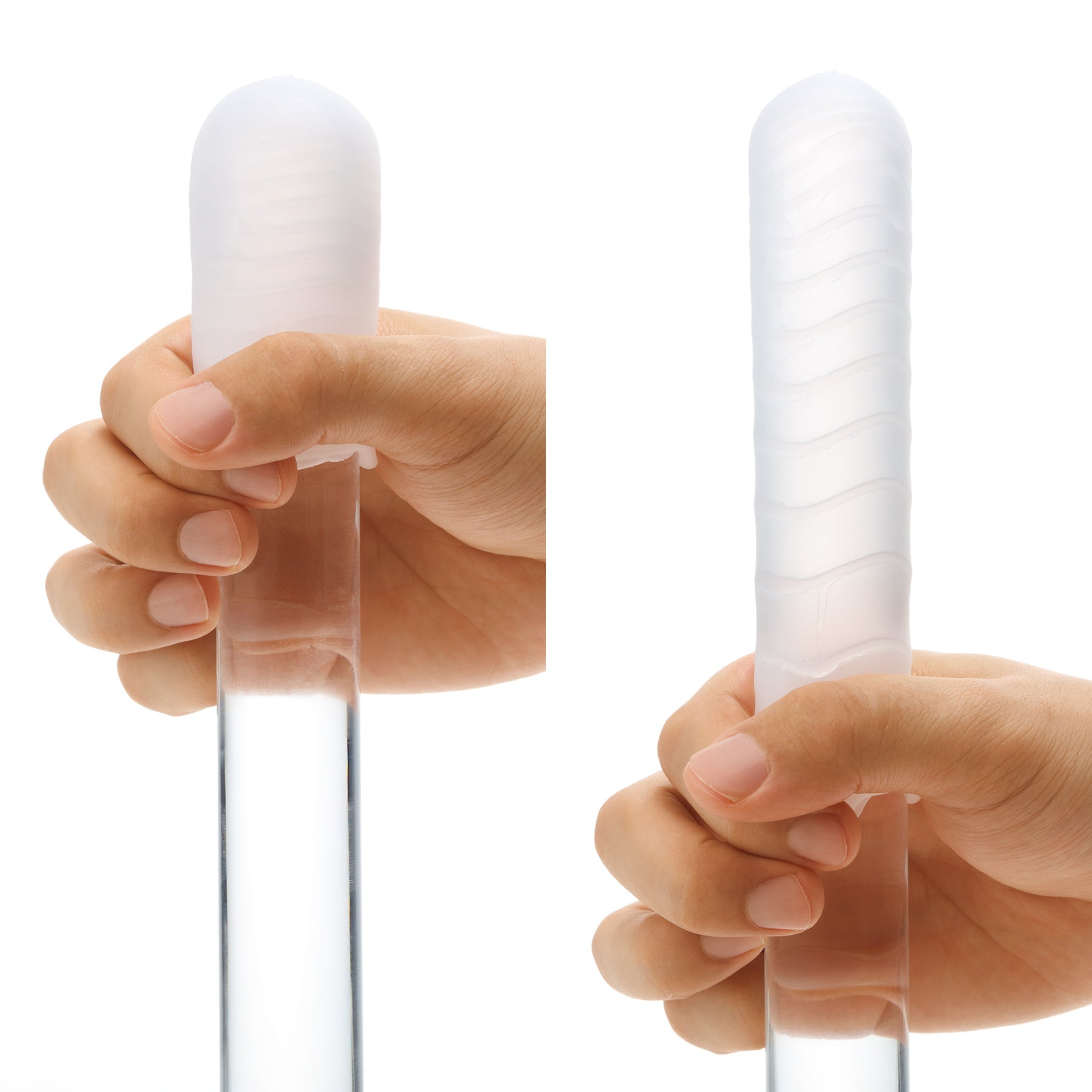 A hand holds a clear cylinder with a textured white sleeve.