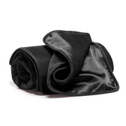 Black waterproof microvelvet blanket rolled up.