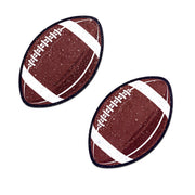 Two sparkly velvet football nipple pasties on a white background.