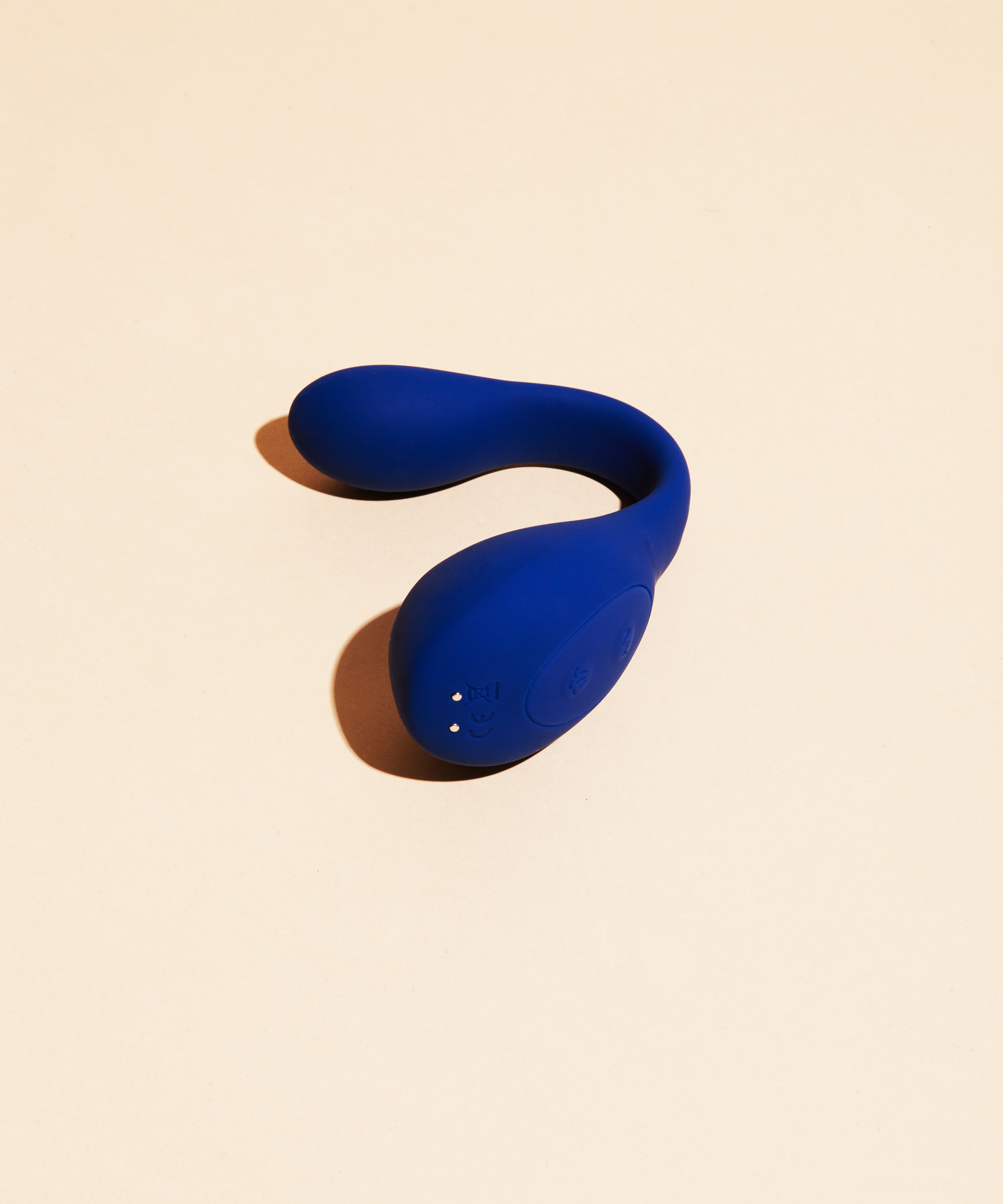 A blue dual stimulation vibrator with a curved shape.