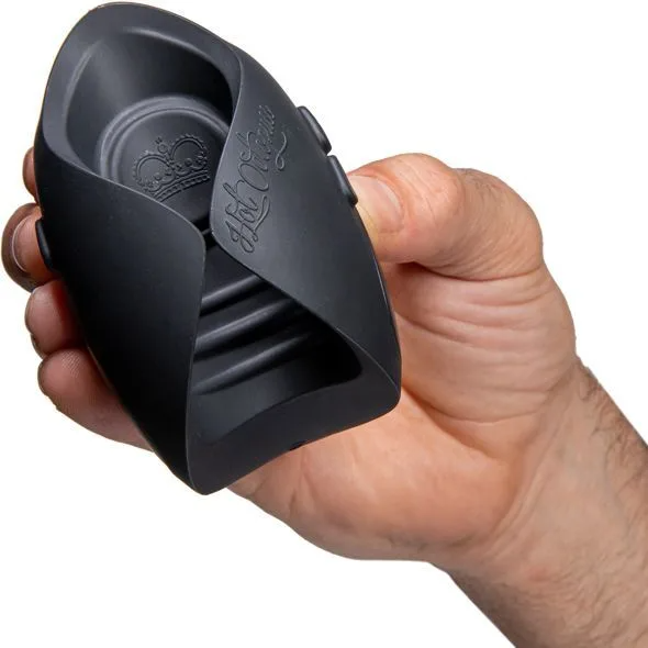 A black oscillating penis toy with a crown logo held in a hand.