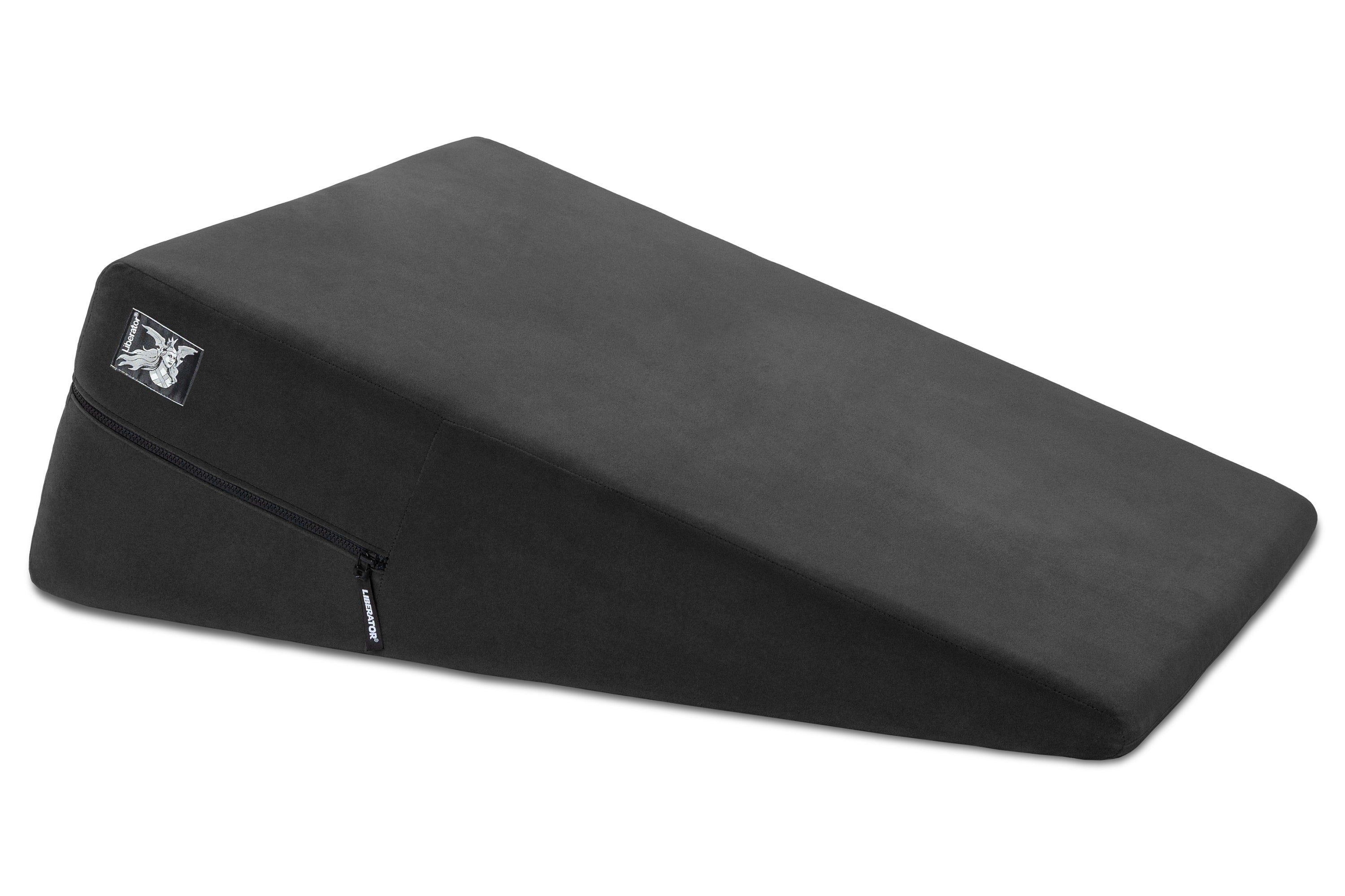 A black wedge-shaped positioning pillow with a microfiber cover and a visible zipper.