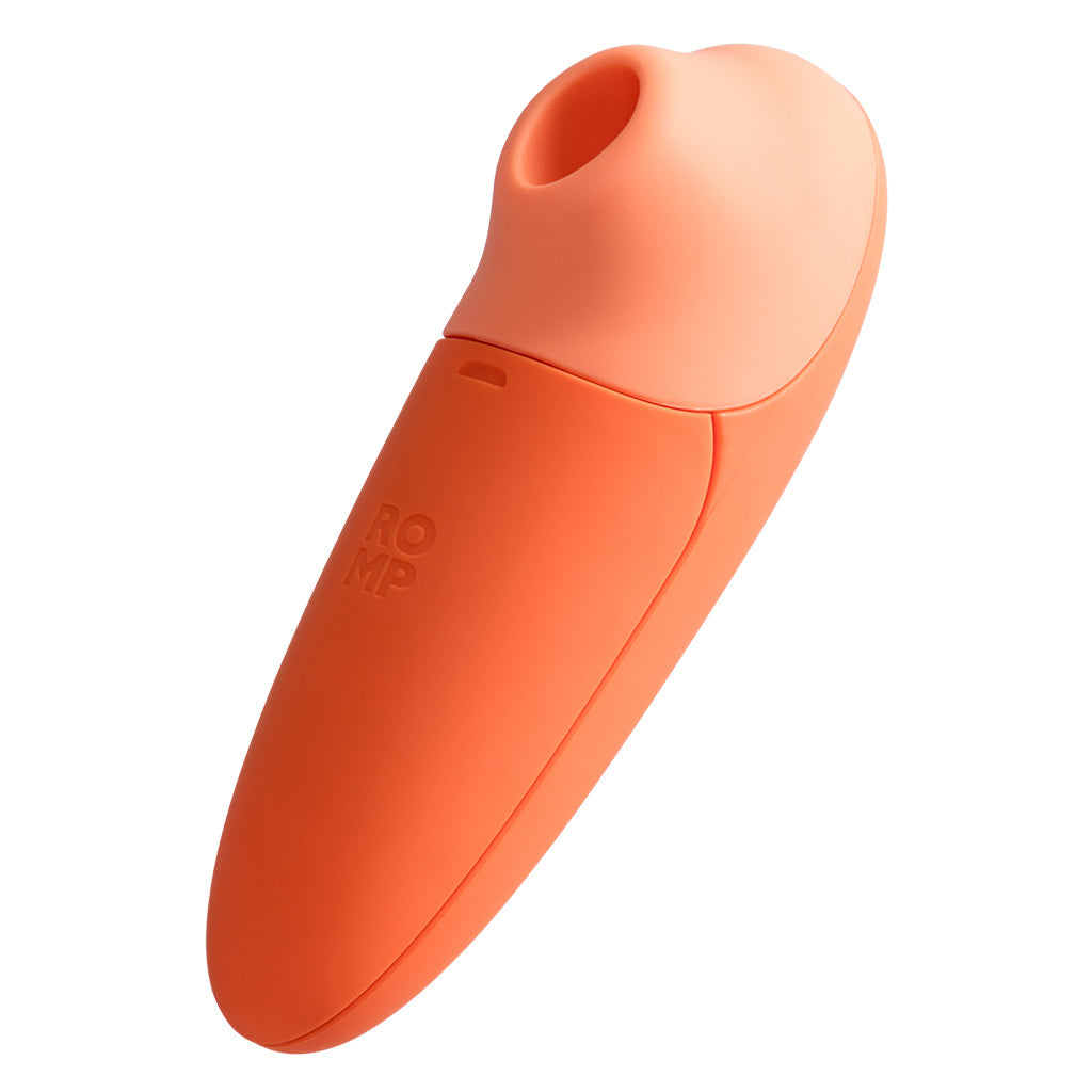 An orange and peach clitoral suction stimulator with the word ROMP embossed on it.