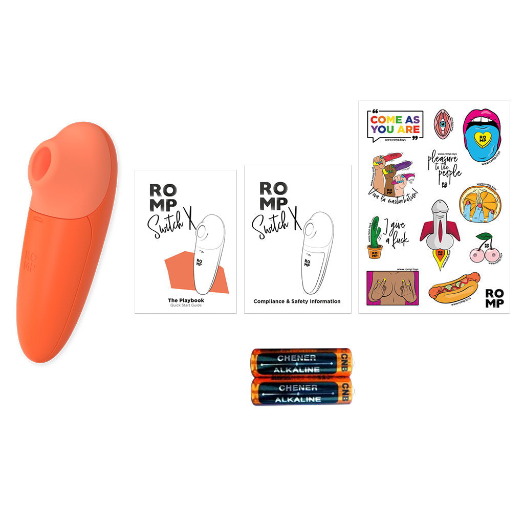 An orange clitoral stimulator with two instruction booklets and two AAA batteries.