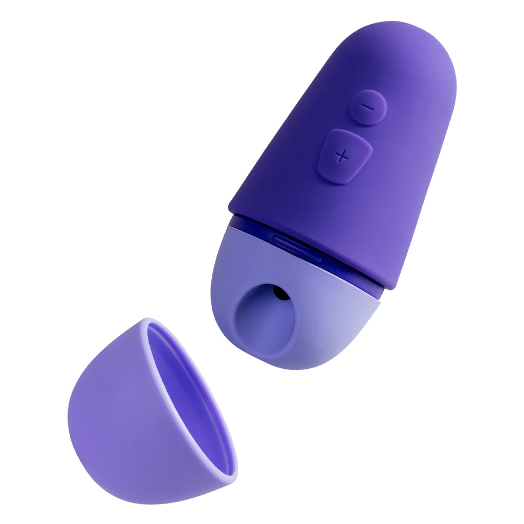 Purple and light purple clitoral stimulator with a detached cap.