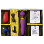 A ROMP Pleasure Kit with a purple wand, red stimulator, blue ring, and charging cables.