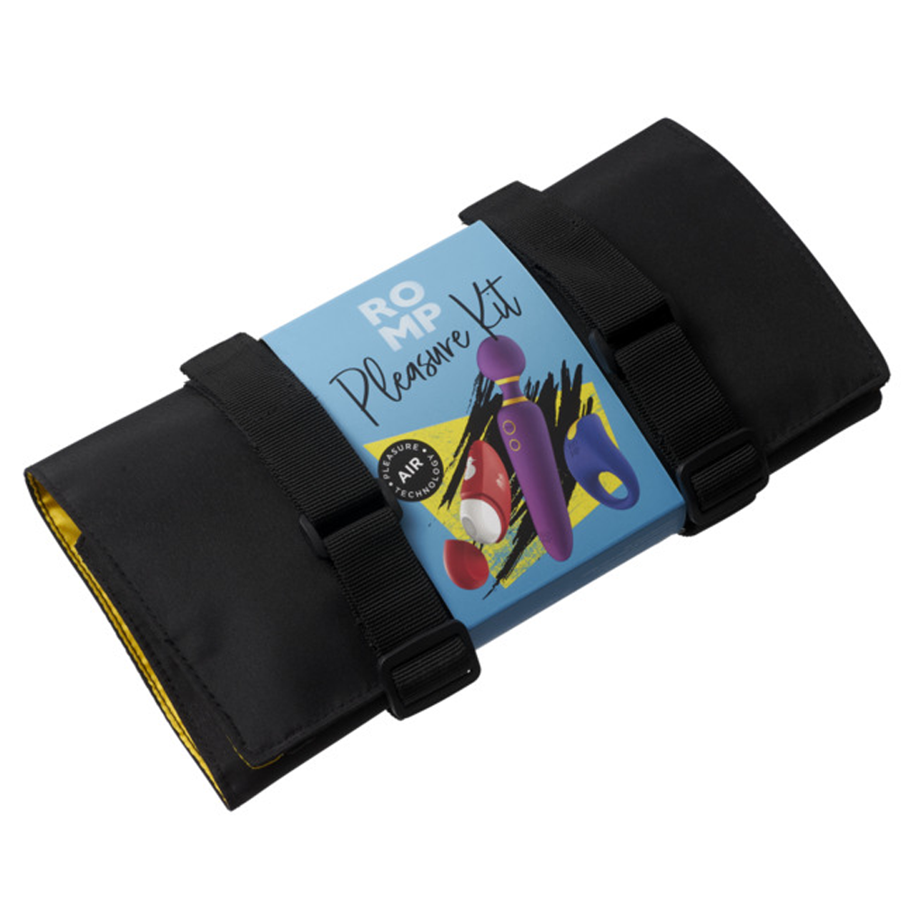 A black pouch with straps holds a blue box labeled "ROMP Pleasure Kit" with images of vibrators.