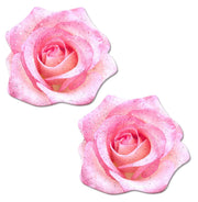 Two pink glitter velvet rose nipple pasties on a white background.