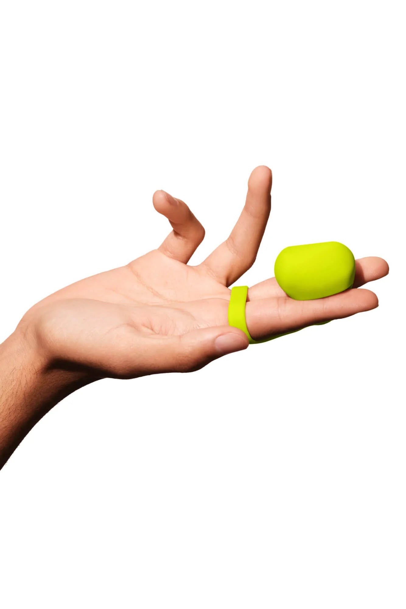 A lime green silicone finger vibrator with a ring on a hand.
