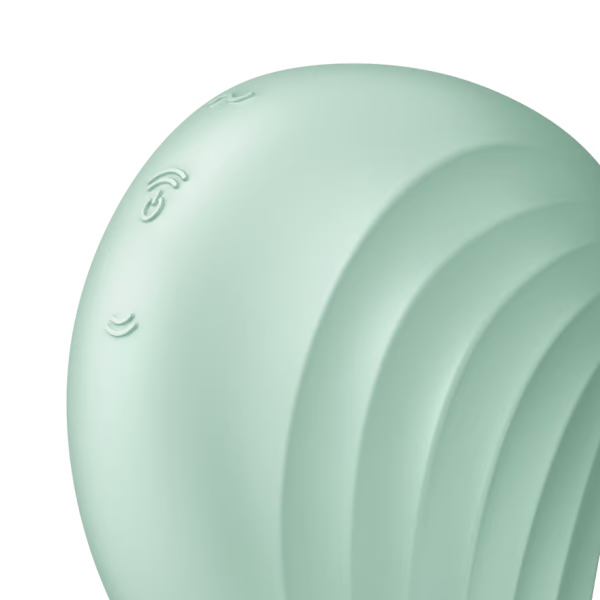 A light green clitoral massager with wave-like ridges and embossed symbols.