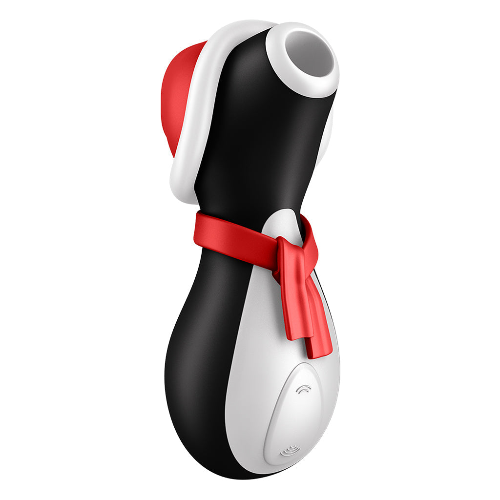 A black and white penguin-shaped clitoral stimulator with a red hat and scarf.