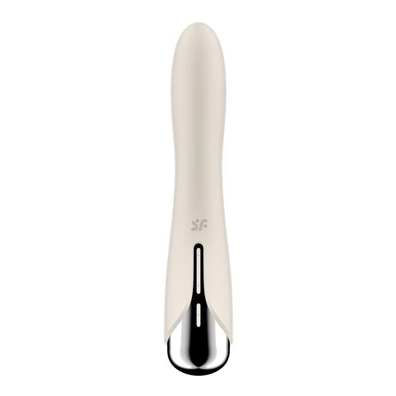 A beige vibrator with a silver tip and a black slit.