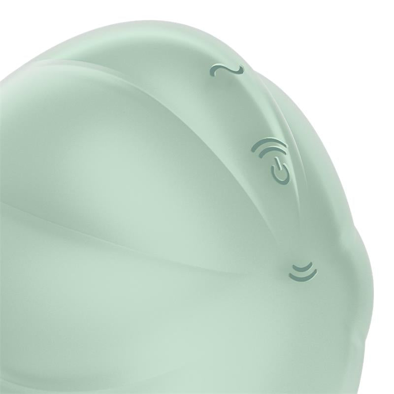 A light green silicone clitoral vibrator with embossed symbols.