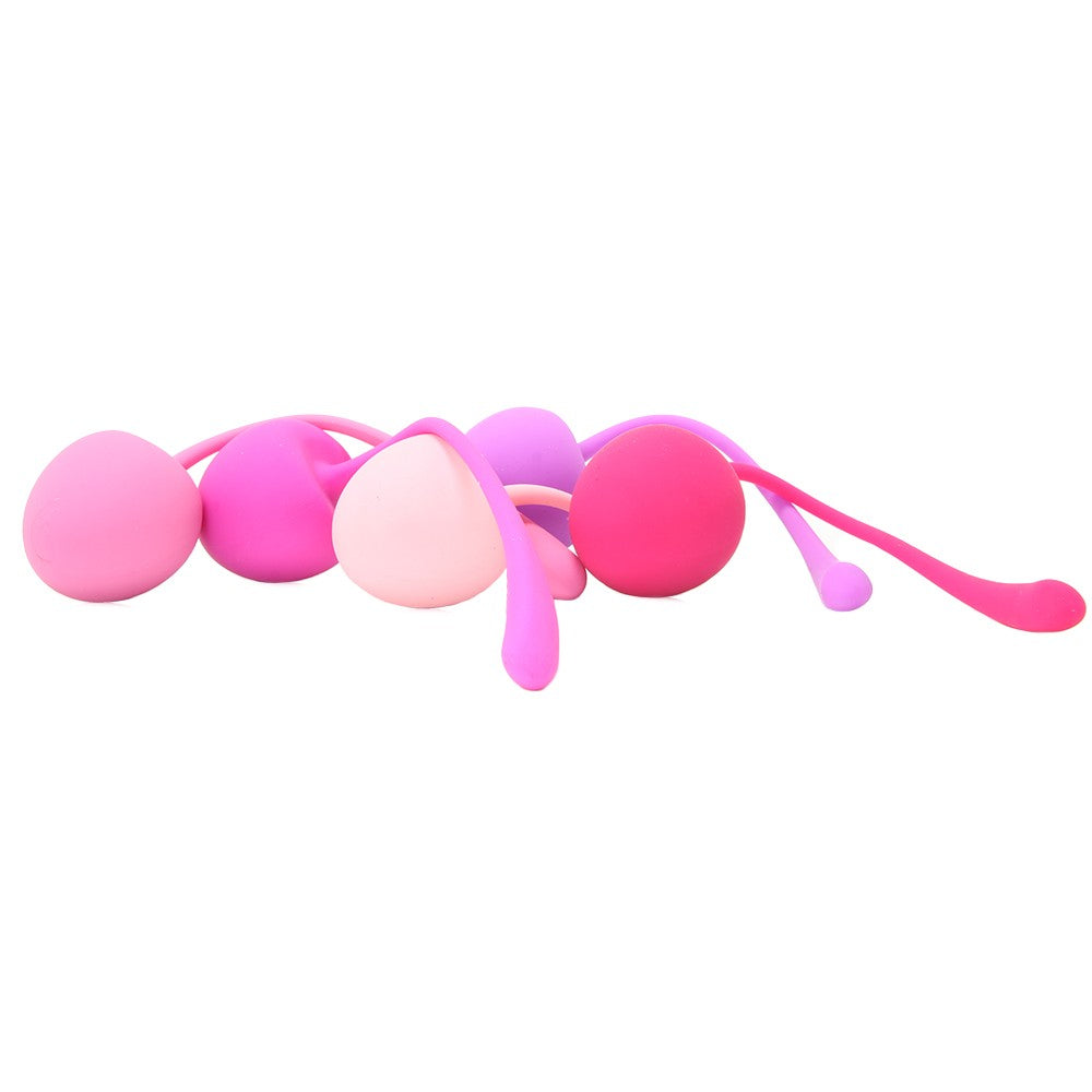 A set of five pink and purple silicone kegel balls with flexible stems.