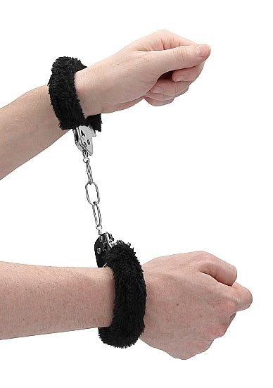 Black furry metal handcuffs with a chain connector.