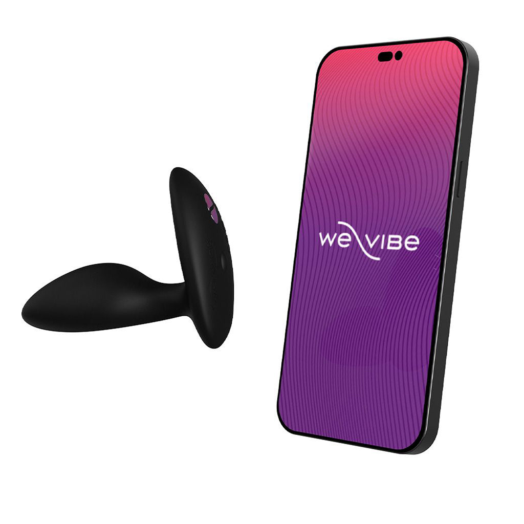 Black silicone anal plug with a remote control and a smartphone displaying the We-Vibe logo.