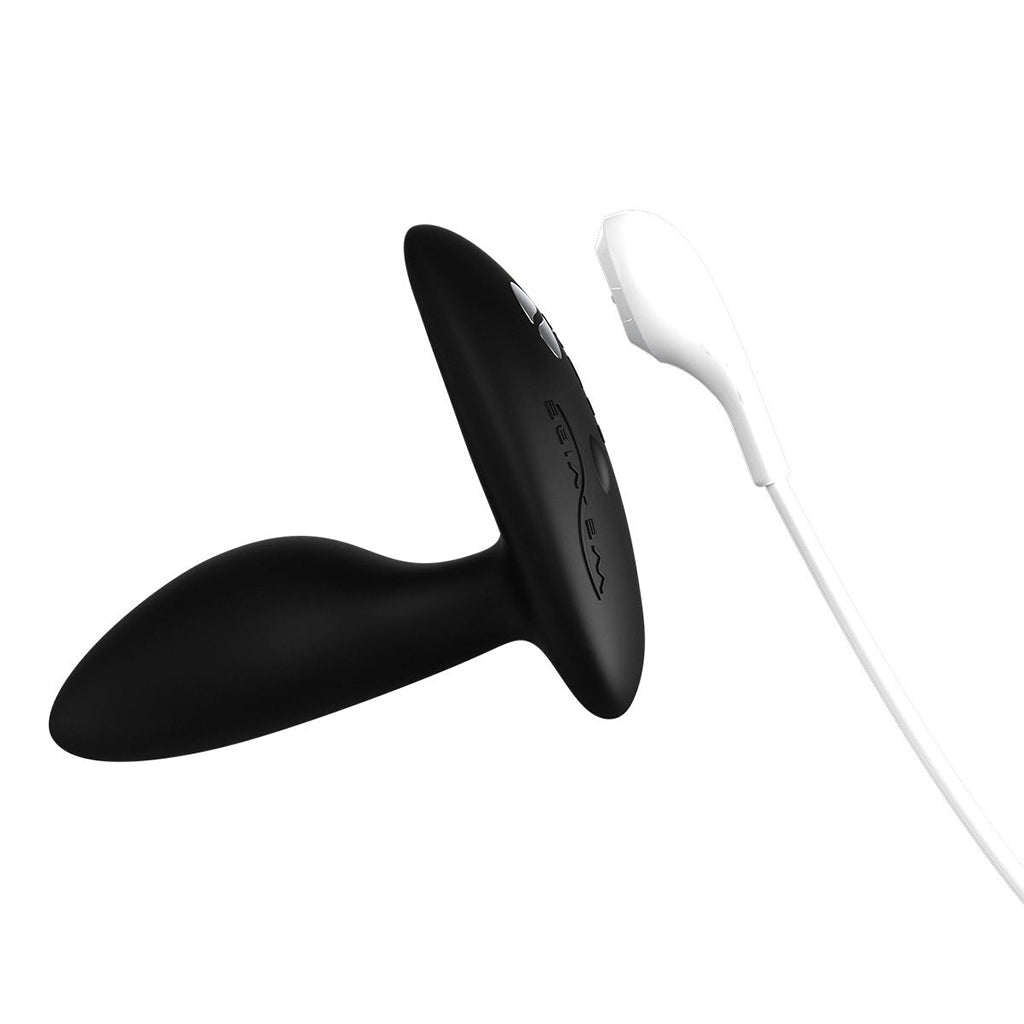 Black silicone anal plug with a white remote control.